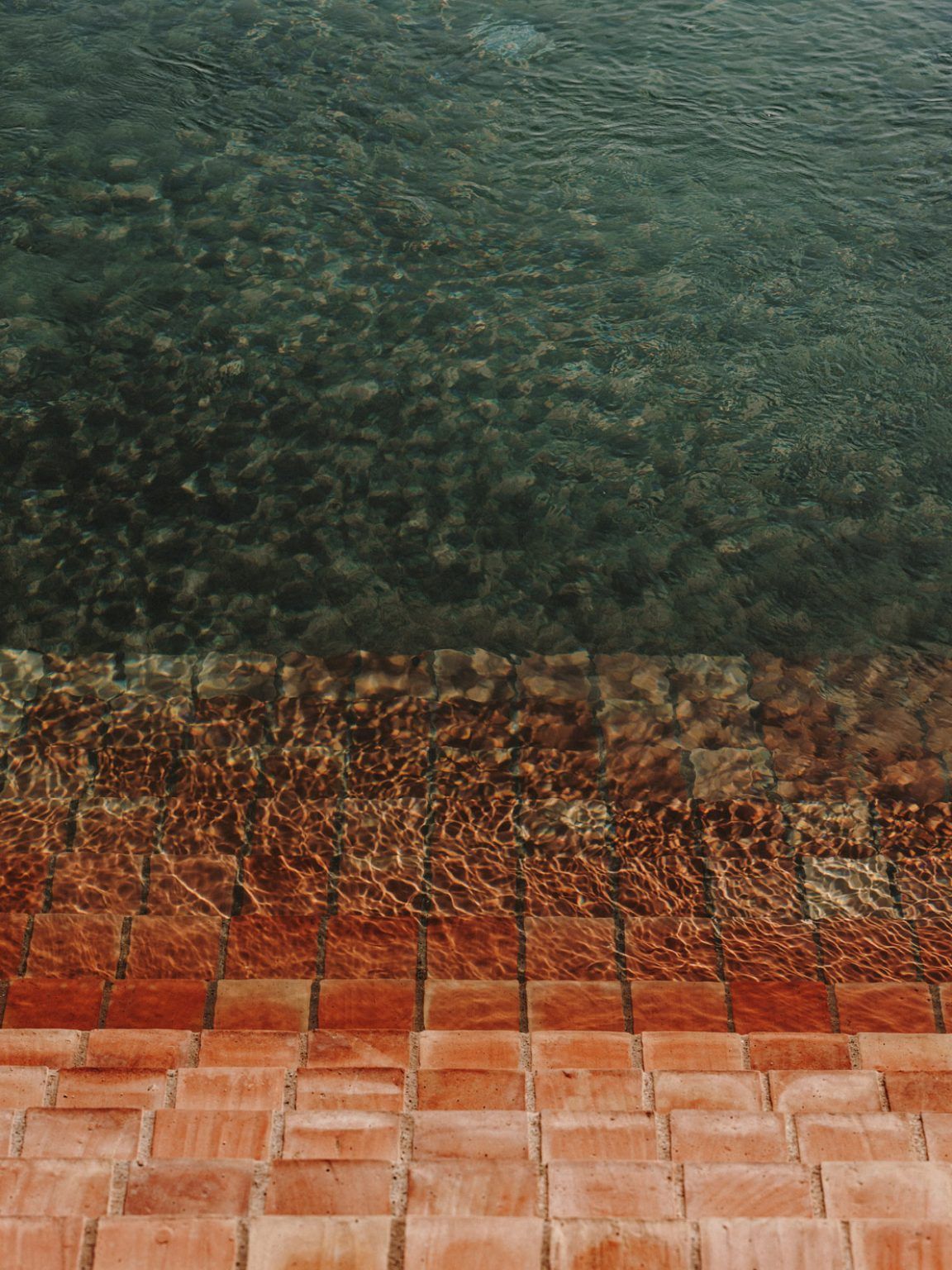 Pool water over terracotta edge